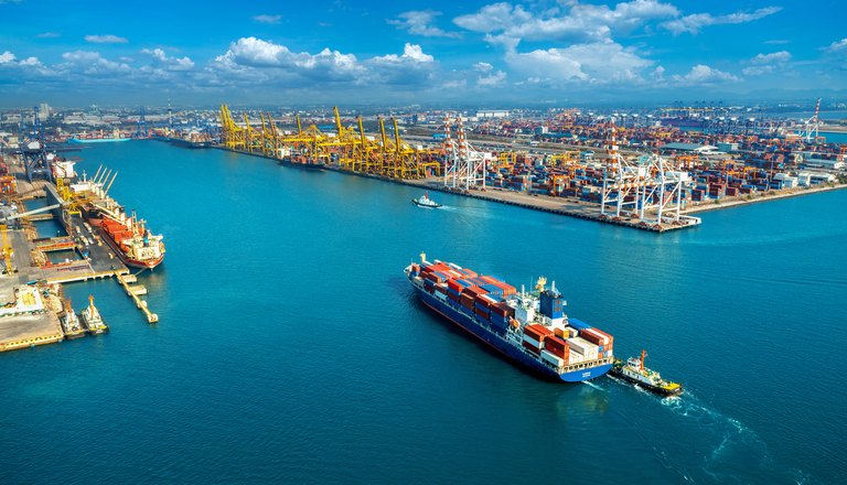 Container ship leaving a busy port