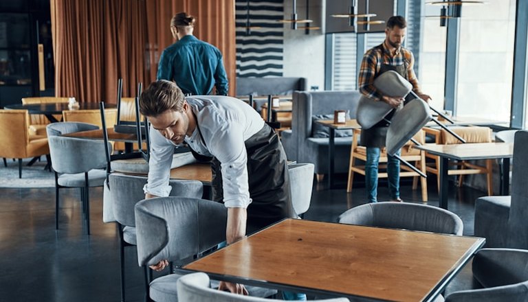 Staff setting up a restaurant floor