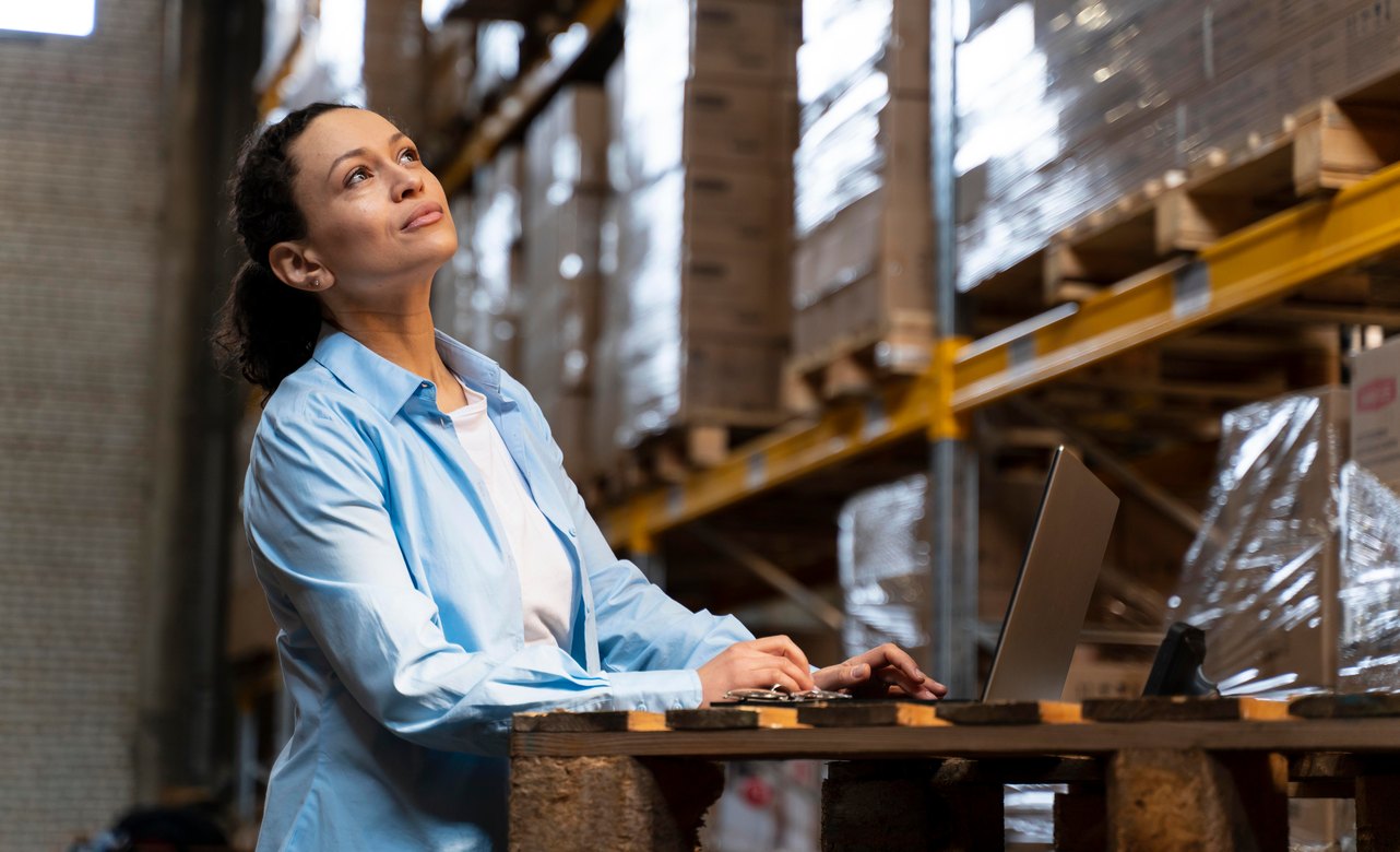 Warehouse operator checking stock on a laptop